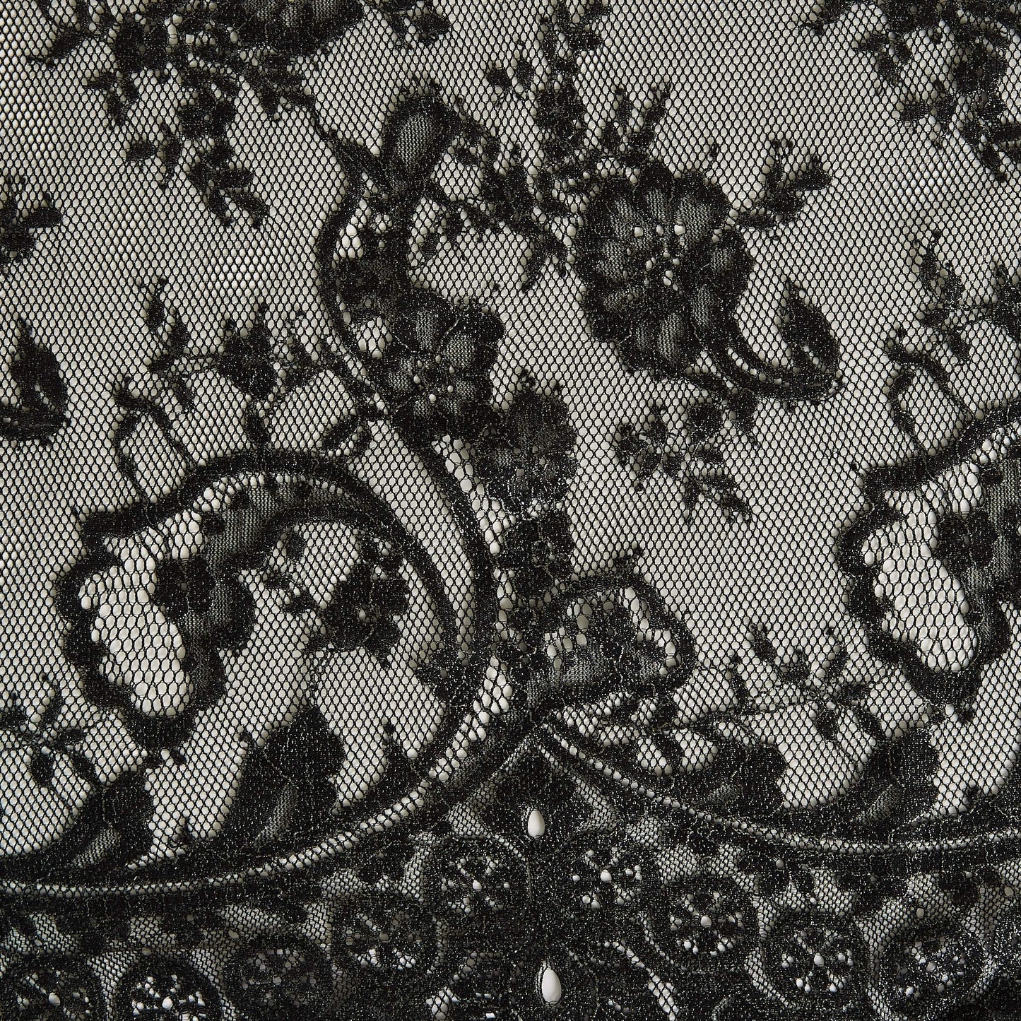 Showing Tivoli a metallic antique Black  panelled lace with eyelash detailing on a nylon, rayon and cotton blend with metallic print